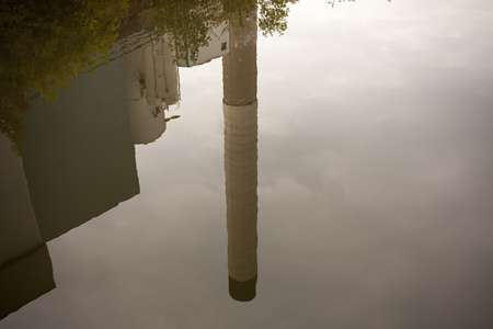 a smoking chimney on the water of a house in front of the evening skyの写真素材