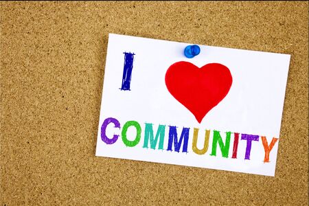 Conceptual hand writing text caption inspiration showing Community. Business concept for togetherness love written on sticky note, reminder cork background with spaceの写真素材