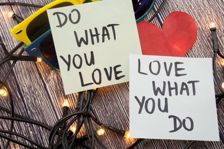 Do what you love, love what you do - motivational word abstract on sticky note wooden backgroundの写真素材