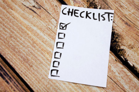 Close up of pin and to do list Checklist word on sticky note and wooden backgroundの写真素材