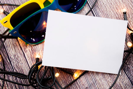 Place for writing sticky note pinned on the wooden background and lights
