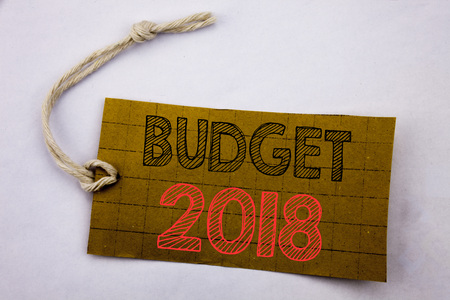 Handwriting Announcement text showing Budget 2018. Business concept for online saleHousehold budgeting accounting planning written on price tag paper on white vintage background.の写真素材
