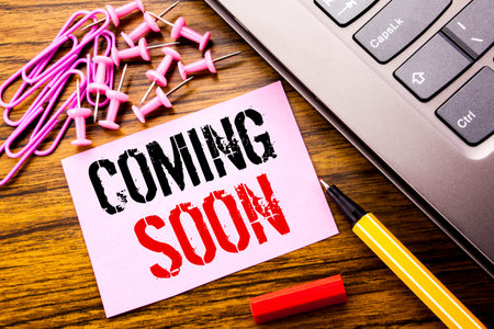 Handwritten text showing Coming Soon. Business concept for Message Future written on pink sticky...