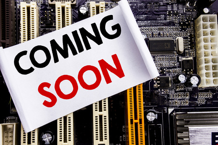 Word, writing Coming Soon. Business concept for Message Future Written on sticky, computer main board background.の写真素材