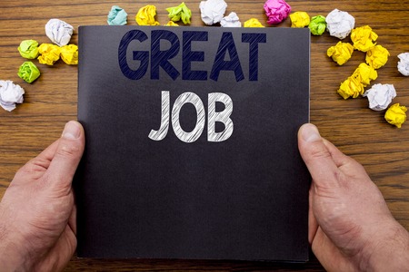 Word, writing Great Job. Business concept for Success Appreciation written notepad notebook book on the wooden wood background with man businessman hand and finger.の写真素材