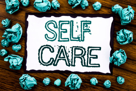 Handwriting Announcement text showing Self Care. Business concept for Taking caring for own Health Written on sticky note paper, wooden background folded blue paper meaning thinking 