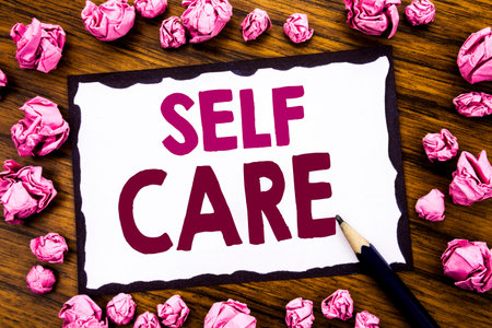 Hand writing text caption inspiration showing Self Care. Business concept for Taking caring for own Health Written on sticky note paper, wooden background folded pink paper meaning thinking の写真素材