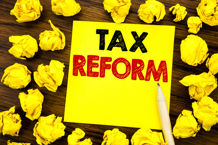 Writing text showing Tax Reform. Business concept for Government Change in Taxes Written on sticky note paper, wooden background folded yellow paper meaning thinkingの写真素材
