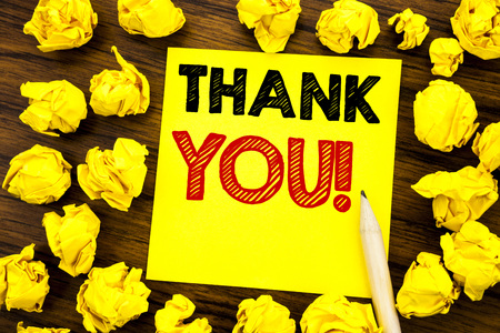 Writing text showing Thank You. Business concept for Thanks Message Written on sticky note paper, wooden background folded yellow paper meaning thinkingの写真素材