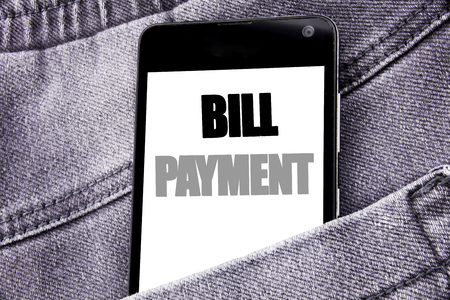 Hand writing text caption inspiration showing Bill Payment. Business concept for Billing Pay Costs written mobile cell phone with space in the back pants trousers pocketの写真素材