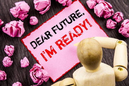 Conceptual hand text showing Dear Future, I Am Ready. Concept meaning Inspirational Motivational Plan Achievement Confidence written Sticky Note Holding By Sculpture the wooden background.の写真素材