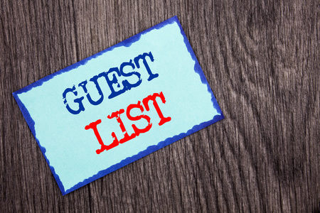 Writing text showing  Guest List. Business photo showcasing Planning Wedding Or Event Important Guests Lists written Blue Sticky Note Paper the wooden background.の写真素材