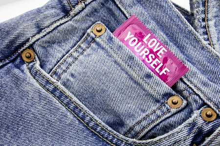 Handwriting Announcement text showing Love Yourself. Business concept for Positive Slogan For You Written on condom pack put in small pocket to pants jeans.の写真素材