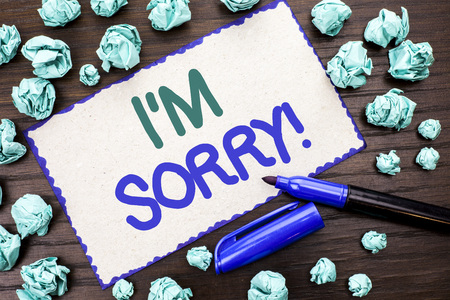 Writing note showing  I m Sorry. Business photo showcasing Apologize Conscience Feel Regretful Apologetic Repentant Sorrowful written Cardboard Piece the wooden background Marker next to it.の写真素材