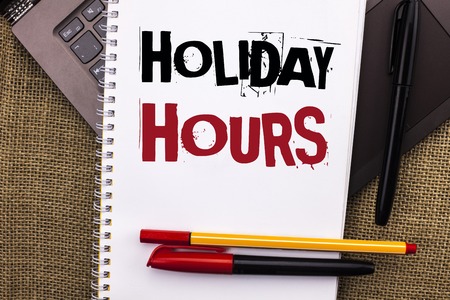 Writing note showing Holiday Hours.の写真素材