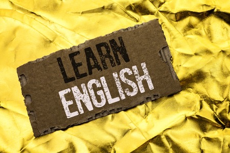 Writing note showing  Learn English. Business photo showcasing Study another Language Learn Something Foreign Communication written tear Cardboard Piece the Golden textured background.の写真素材