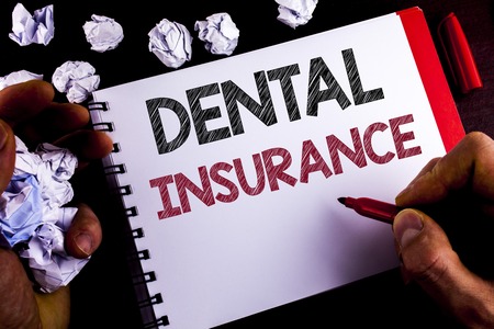 Writing note showing  Dental Insurance. Business photo showcasing Dentist healthcare provision coverage plans claims benefit written by Man Notepad holding Marker wooden background Paper Ballsの写真素材