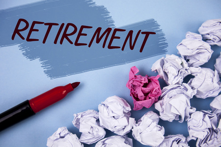 Text sign showing Retirement. Conceptual photo Leaving Job Stop Ceasing to Work after reaching some age written Painted background Crumpled Paper Balls and Marker next to it.の写真素材