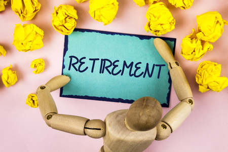 Handwriting text writing Retirement. Concept meaning Leaving Job Stop Ceasing to Work after reaching some age written Sticky note paper within Paper Balls plain background Wooden Toyの写真素材
