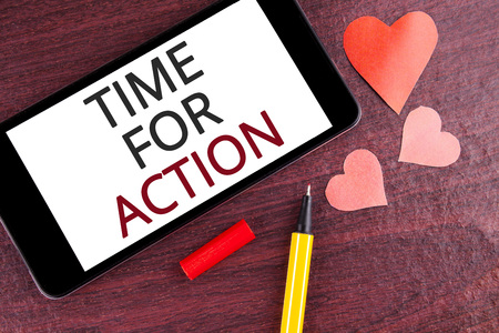 Writing note showing  Time For Action. Business photo showcasing Do something now for a particular purpose Act in this moment written Mobile Phone Screen wooden background Pen and Heartsの写真素材