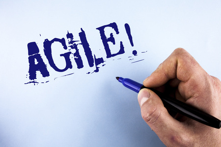 Handwriting text Agile Motivational Call. Concept meaning Develop an agility towards technological chnage written by Man plain background holding Marker in Hand.の写真素材