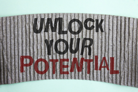 Handwriting text Unlock Your Potential. Concept meaning Reveal talent Develop abilities Show personal skills written Cardboard piece the plain background.の写真素材