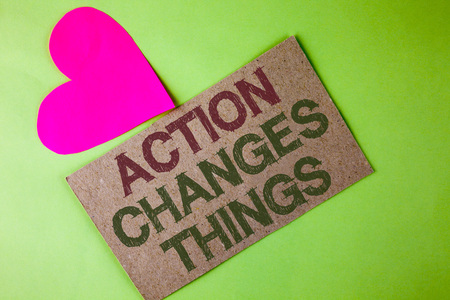 Conceptual hand writing showing Action Changes Things. Business photo text doing something is like chain Improve Reflects written Cardboard Piece the plain background Heart next to itの写真素材