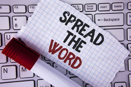 Conceptual hand writing showing Spread The Word. Business photo text Run advertisements to increase store sales many fold written Tear Notebook paper placed the Laptop Marker next to it..の写真素材