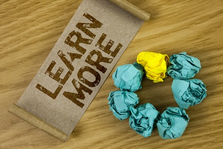 Conceptual hand writing showing Learn More. Business photo showcasing Study harder Develop new skills abilities Get extra education written Cardboard Paper piece wooden background Paper Ballの写真素材