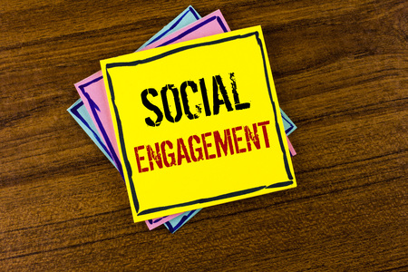 Writing note showing  Social Engagement. Business photo showcasing post gets high reach Likes Ads SEO Advertising Marketing written Yellow Sticky Note Paper the Wooden background.の写真素材