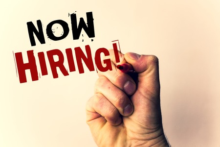 Handwriting texts writing Now Hiring Motivational Call. Concept meaning Workforce Wanted Employees RecruitmentMan holding pen pointing idea message black red letters beige backgroundの写真素材