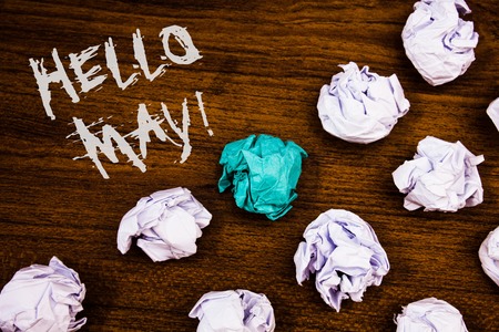 Writing note showing  Hello May Motivational Call. Business photo showcasing Starting a new month April is over SpringIdeas words wooden background chalk letters several tries crumpled papersの写真素材