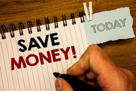 Text sign showing Save Money Motivational Call. Conceptual photo Reduce expenses Make a fund from earningsMan creating for today on notebook Hand hold holding pen Wooden backgroundの写真素材