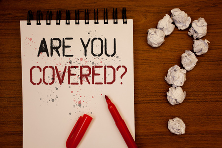 Conceptual hand writing showing Are You Covered Question. Business photo showcasing Have a Security and Health Insurance Medical Care Ideas on notebook wooden background quotation markの写真素材