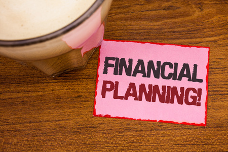 Conceptual hand writing showing Financial Planning Motivational Call. Business photo text Accounting Planning Strategy Analyze Wooden desktop red lined pink paper with several texts coffee mugの写真素材