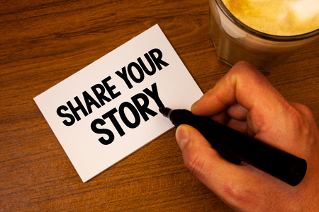 Conceptual hand writing showing Share Your Story. Business photo text Experience Storytelling Nostalgia Thoughts Memory Personal Text white paper hand black marker coffee glass letterの写真素材