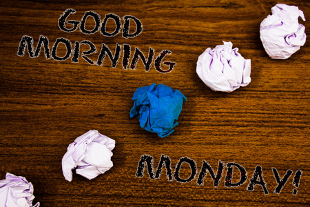 Word writing text Good Morning Monday Motivational Call. Business concept for Happy Positivity Energetic Breakfast Brown woody desktop four white crumpled paper balls central blue oneの写真素材