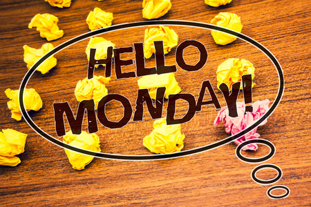 Word writing text Hello Monday Motivational Call. Business concept for Positive Message for a new day Week Start Text wood desk crumbled paper notes yellow pink stress studying schoolの写真素材