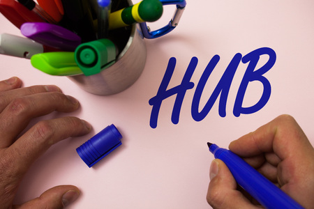 Handwriting text writing Hub. Concept meaning Device connecting computers Center of Wheel Activities Transportation Man working inspiration holding marker notebook ideas white backgroundの写真素材