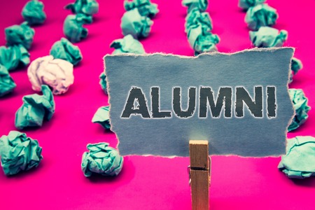 Handwriting text writing Alumni. Concept meaning Alum Old graduate Postgraduate Gathering College Academy Celebration Clothespin holding green paper crumpled papers ideas mistakes several triesの写真素材