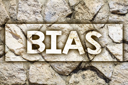 Writing note showing  Bias. Business photo showcasing Unfair Subjective One-sidedness Preconception Inequality Bigotry Ideas message stone stones rock rocks backgrounds wild natural pebblesの写真素材