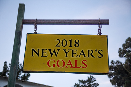 Handwriting text 2018 New Years Goals. Concept meaning resolution List of things you want to achieve Messages object location yellow banner frame metal board billboard yellowの写真素材