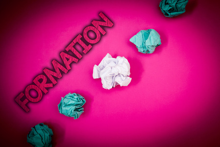 Conceptual hand writing showing Formation. Business photo text Body of rocks Particular Troops Parts disposition Forming process Ideas messages pink background crumpled papers several triesの写真素材