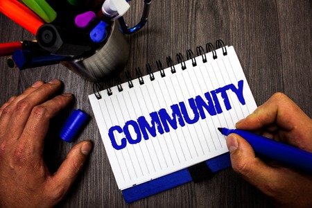 Handwriting text writing Community. Concept meaning Neighborhood Association State Affiliation Alliance Unity Group Man hold holding marker notebook ideas markers wooden table inspirationの写真素材
