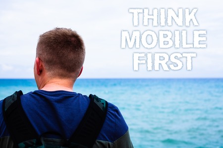 Text sign showing Think Mobile First. Conceptual photo Handheld devises marketing target portable phones first Blue beach water Messages Ideas Thoughts sky human natural beautifulの写真素材