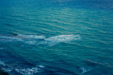Deep Blue Ocean Surface with Waves and Foaming, Dark Turquoise Water Waving at the pace of the...