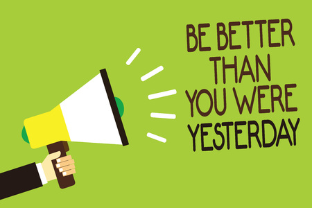Conceptual hand writing showing Be Better Than You Were Yesterday. Business photo showcasing try to improve yourself everyday Man holding megaphone green background message speaking loudの写真素材