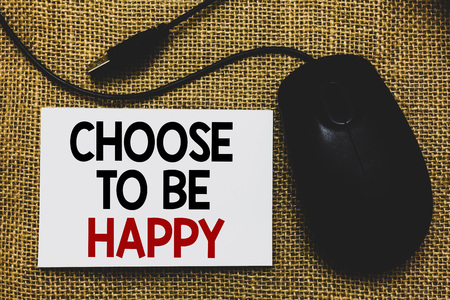 Writing note showing Choose To Be Happy. Business photo showcasing Decide being in a good mood smiley cheerful glad enjoy Traditional mouse alongside white page with written wordsの写真素材