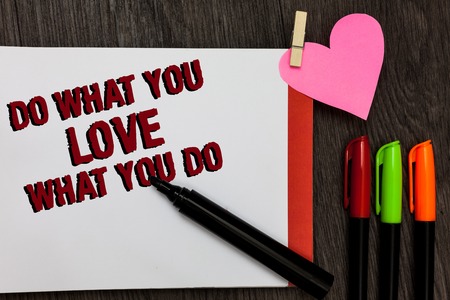 Writing note showing Do What You Love What You Do. Business photo showcasing Make things that motivate yourself Passion Bold red words pen on page small heart corner pens laid seriallyの写真素材