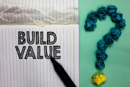 Conceptual hand writing showing Build Value. Business photo text efficient enough way that it will generate profit after cost Notebook marker crumpled papers question mark on green backgroundの写真素材